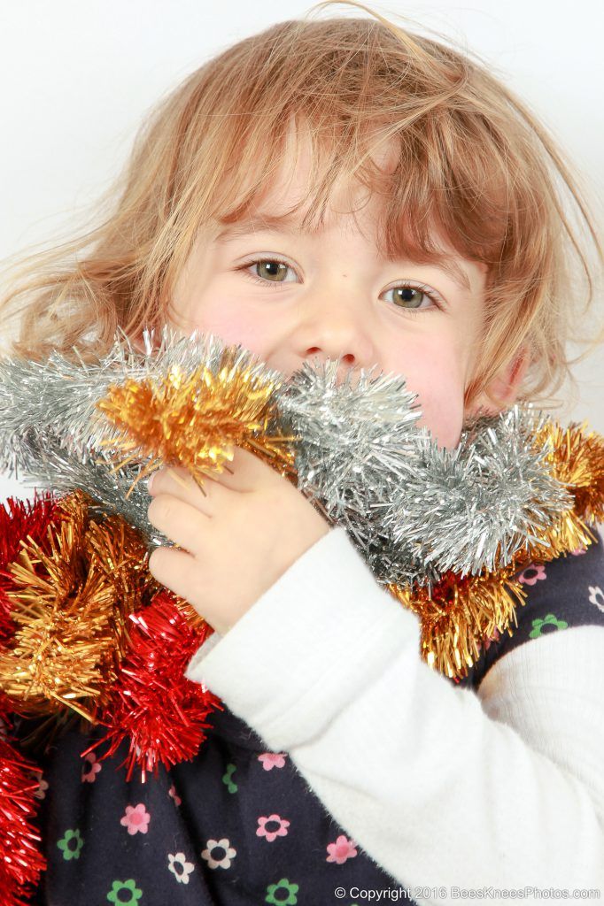 a girl wrapped in a tinsel scarf