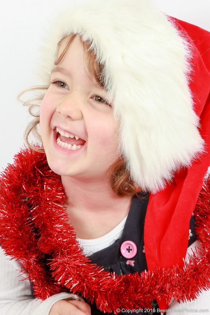 a young girl wearing a santa hat
