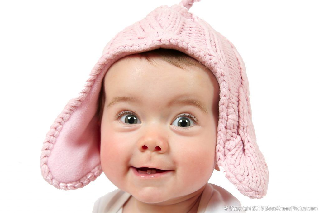 baby wearing a cute pink woollen hat