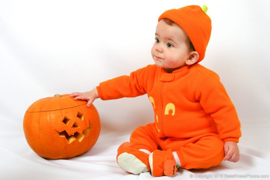 baby with a pumpkin at halloween