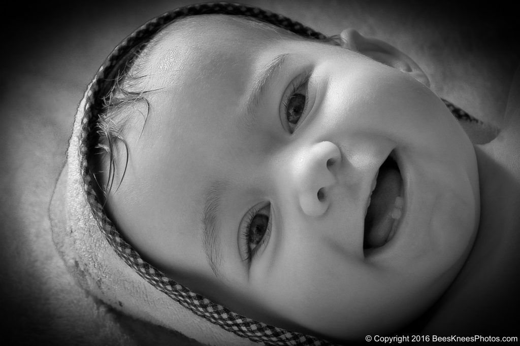 black and white photo of a smiling happy baby