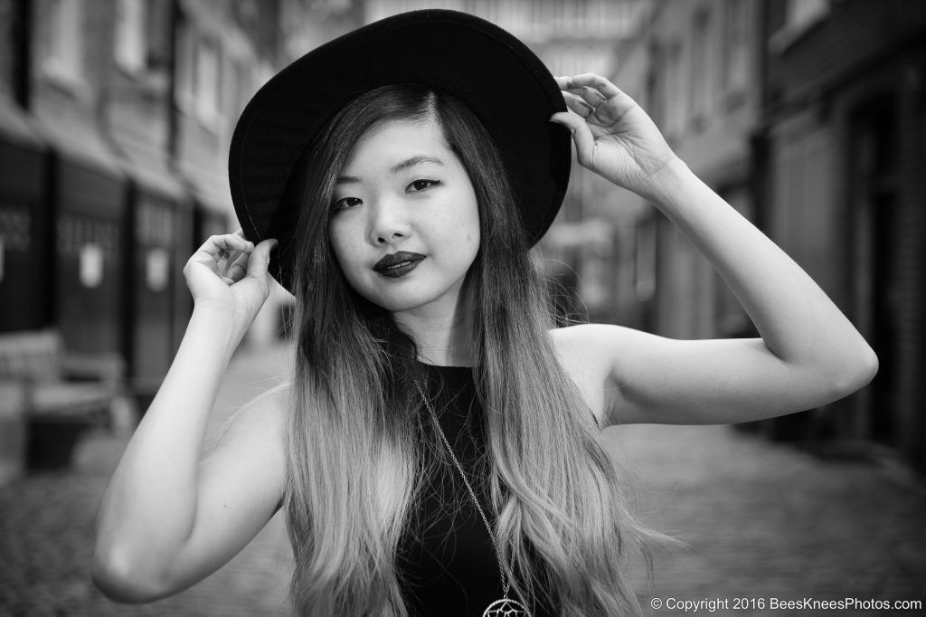 black and white portrait of a woman in a stylish black hat