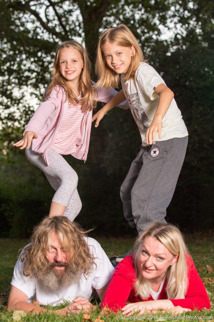 brother and sister standing on dad and mum