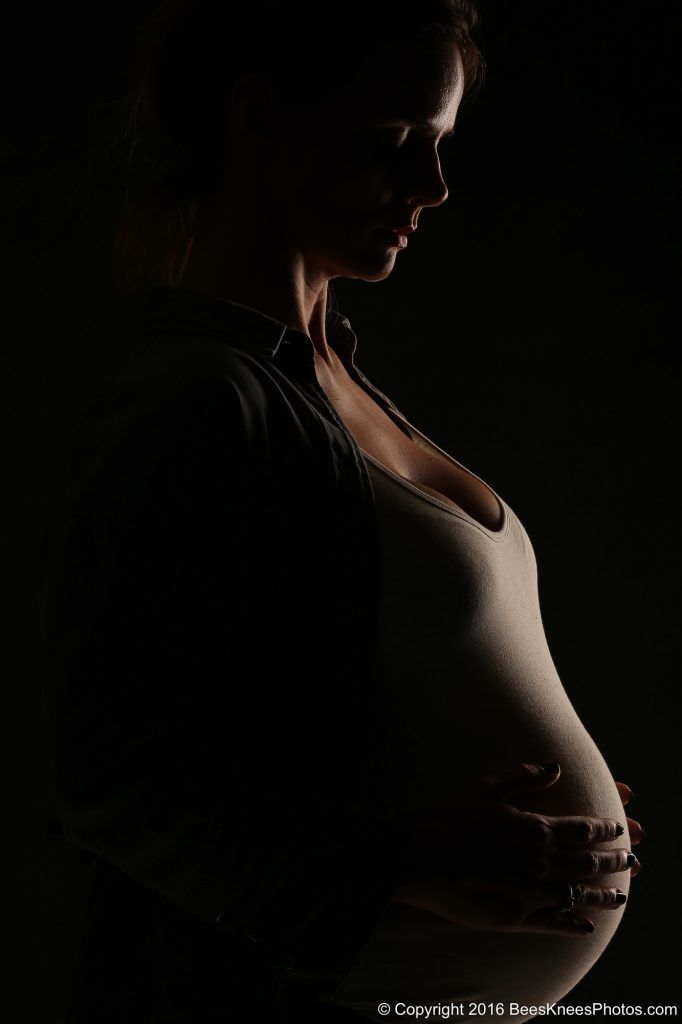 dark portrait of a pregnant woman