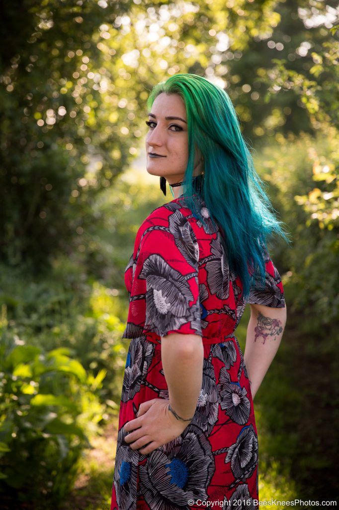 green haired woman in the woods