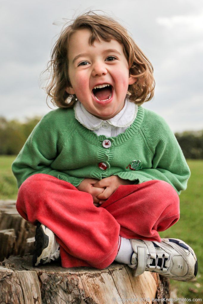happy young girl on an outdoor family photoshoot