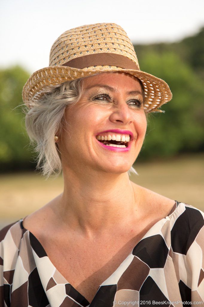 laughing woman wearing a straw hat