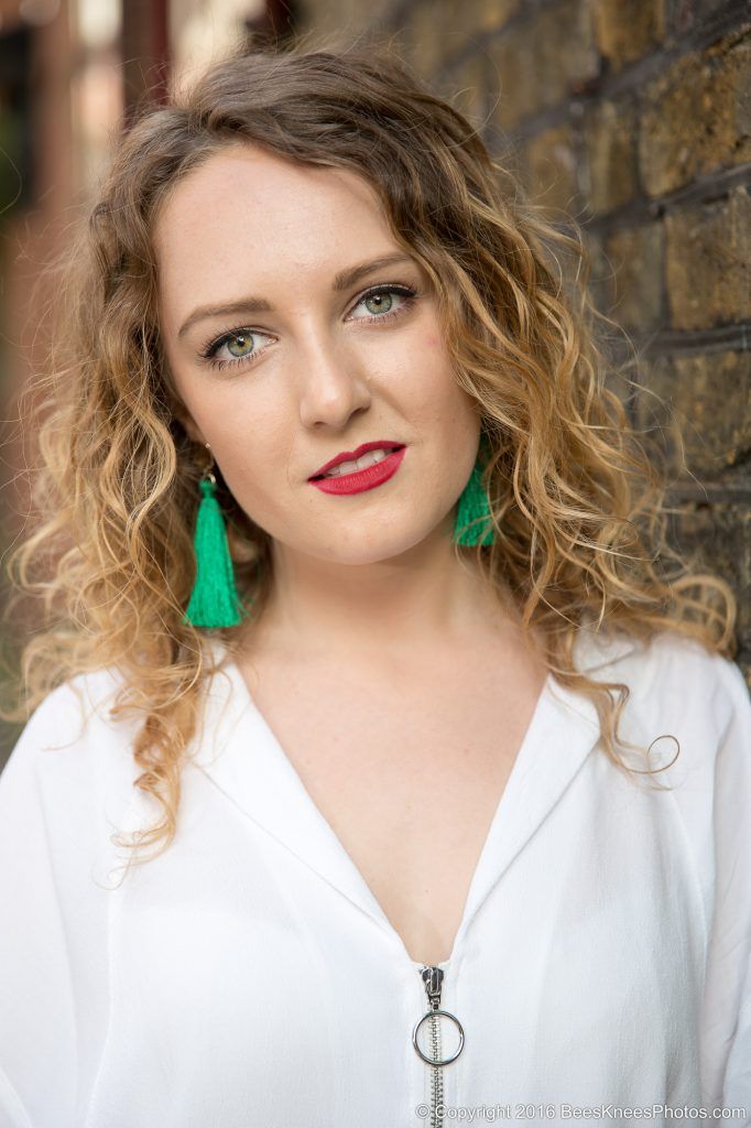 photo of a woman with green earrings