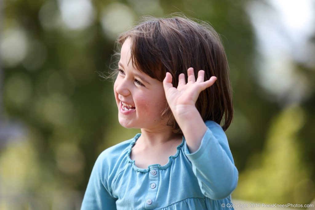 portrait of a young girl waving