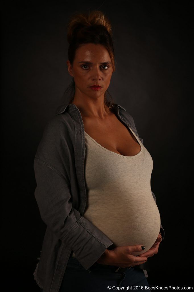 pregnant woman holding her bump
