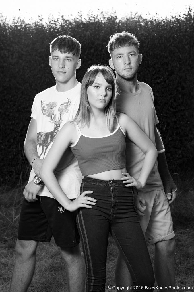 teenage brothers and sister posing
