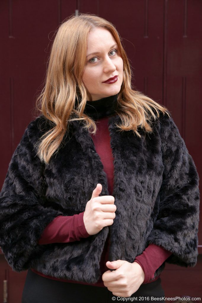 woman in a fluffy black jacket