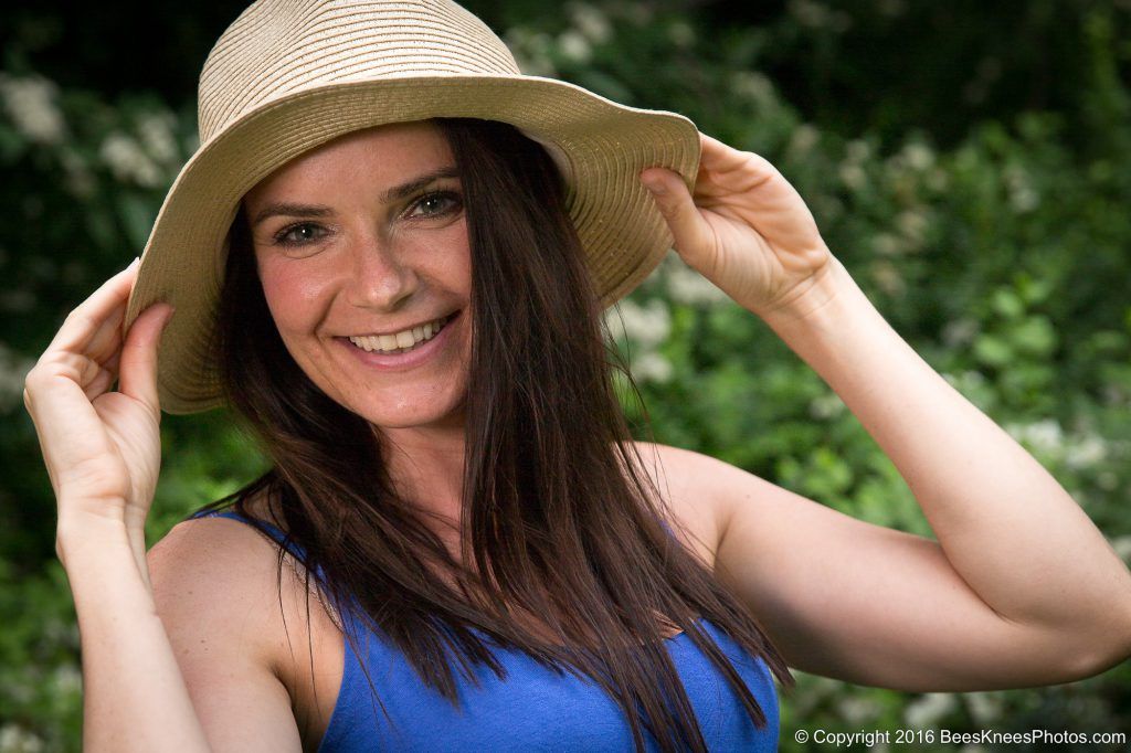 woman in blue wearing a straw hat