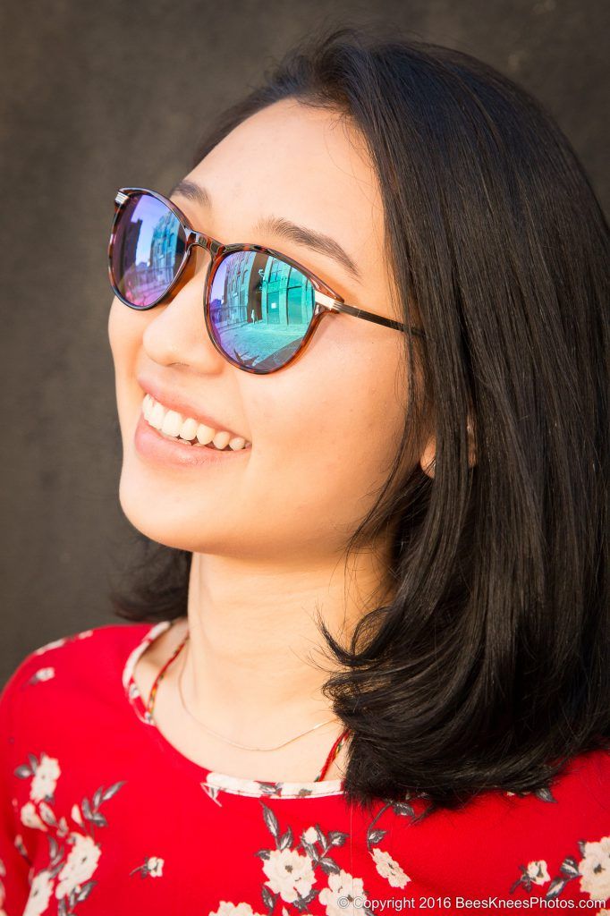 woman in red wearing blue sunglasses