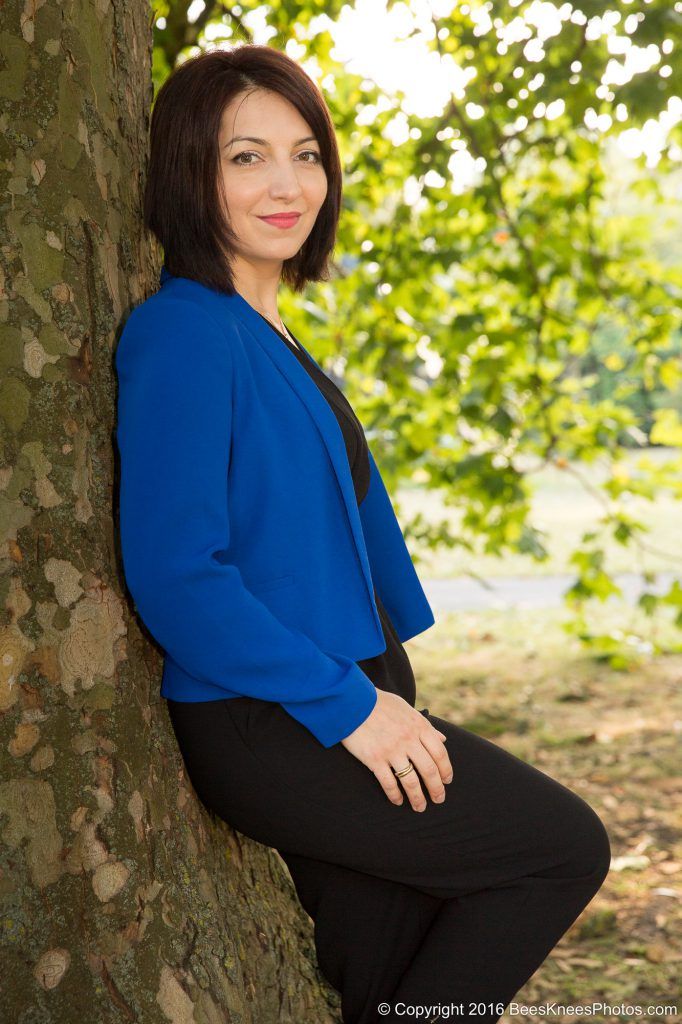 woman leaning against a tree