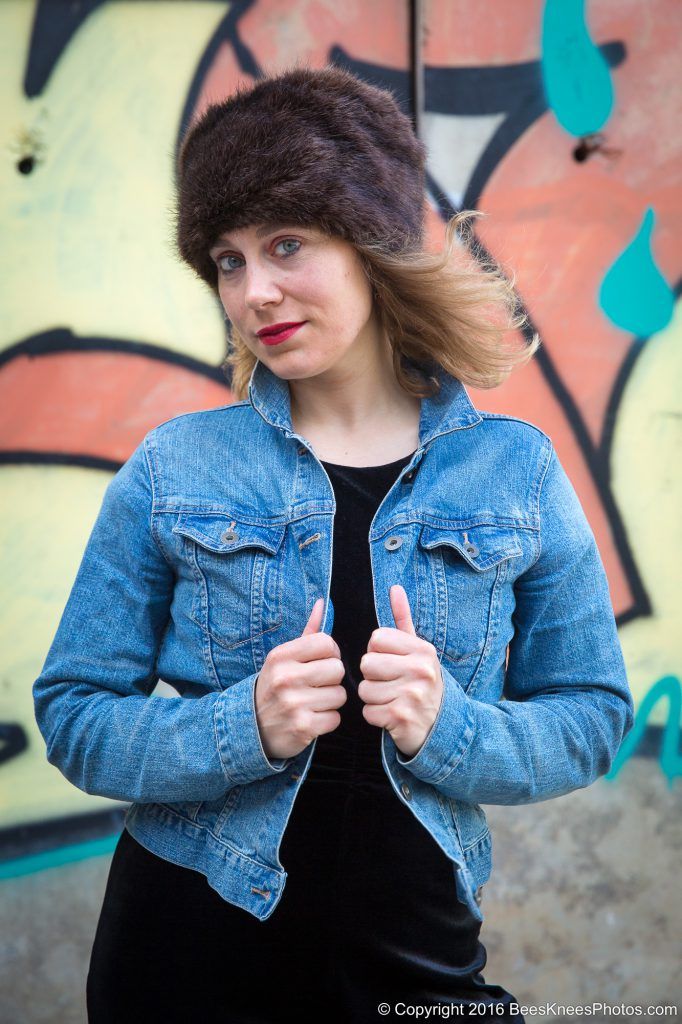 woman standing in front of graffiti