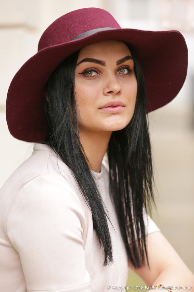 woman wearing a stylish burgundy hat