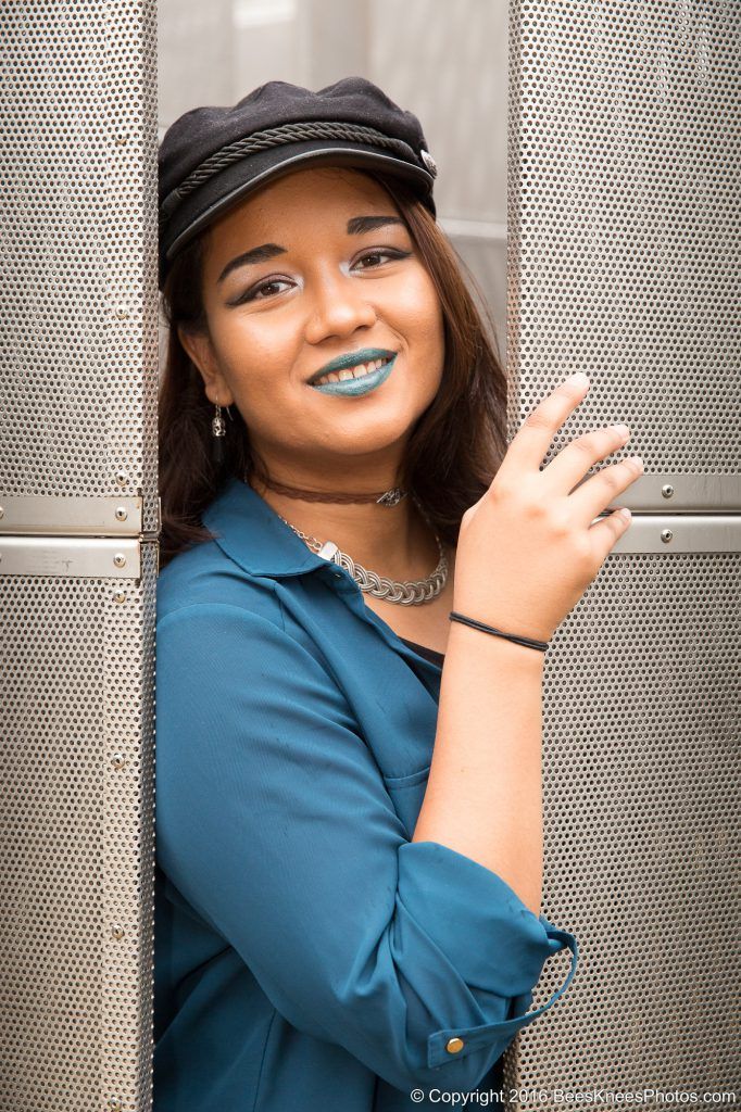 woman with blue lipstick and a black cap
