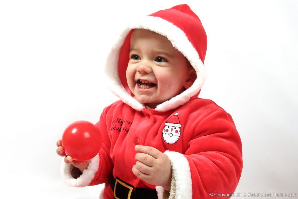 young girl dressed up as santa at christmas