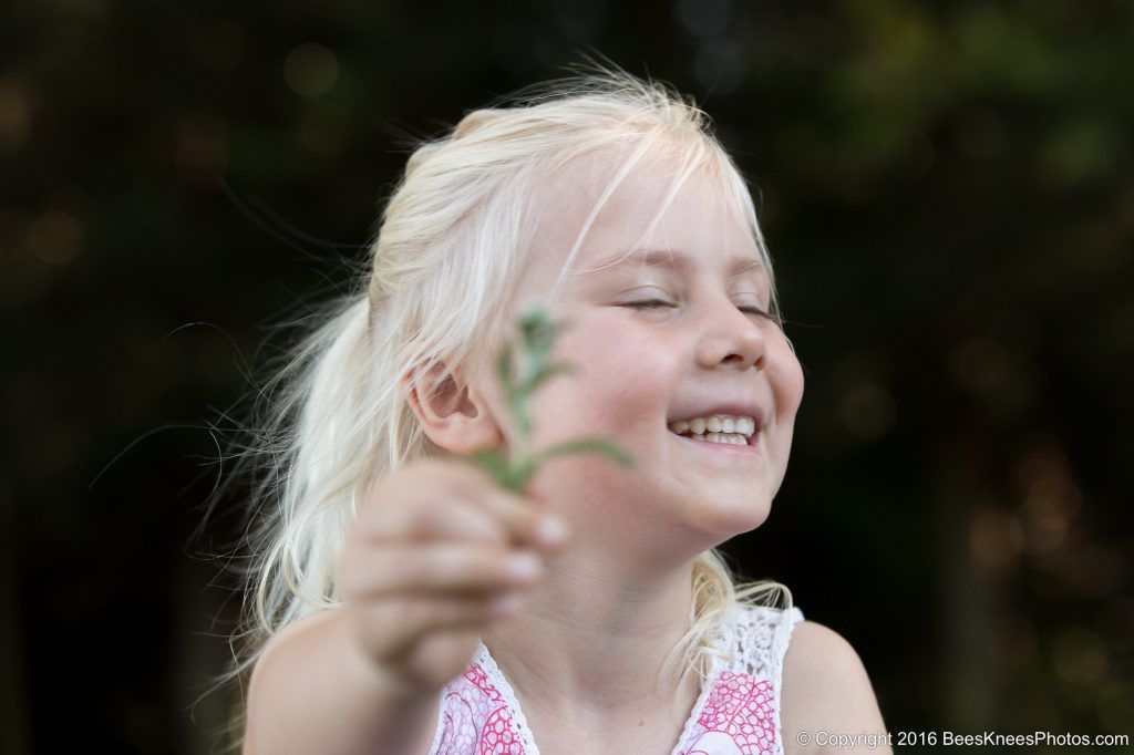 young girl picking flowers