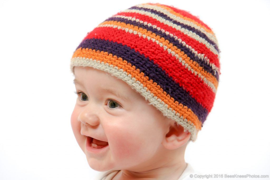 young girl wearing a cute striped beanie