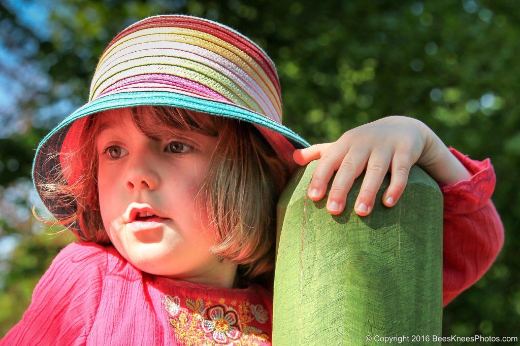 young girl wearing a striped hat